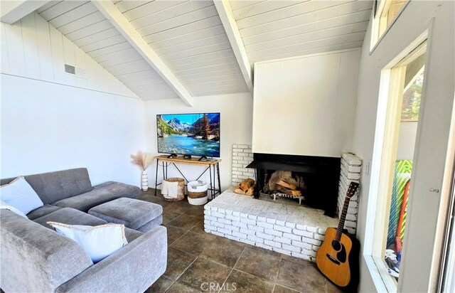 living room featuring lofted ceiling with beams, a fireplace, and wood ceiling
