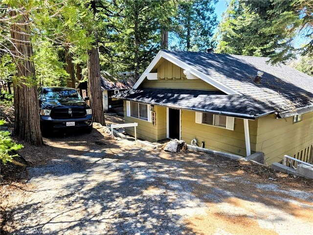 628 Rose Ln, Twin Peaks, CA 92391 - view of front of home with a shingled roof, board and batten siding, and driveway