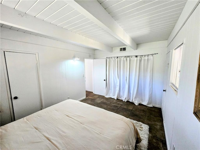 bedroom featuring visible vents and beamed ceiling