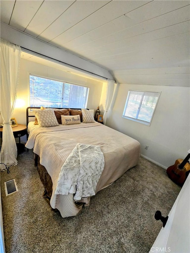 carpeted bedroom featuring visible vents and multiple windows