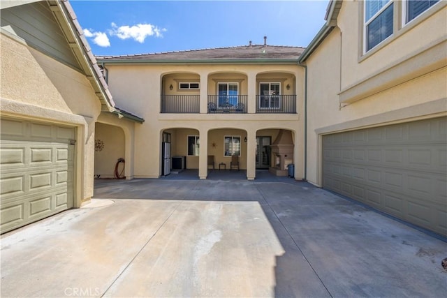3274 Rural Ln, Corona, CA 92882 - view of exterior entry with a balcony, driveway, stucco siding, and an attached garage