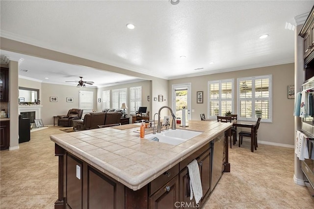 3274 Rural Ln, Corona, CA 92882 - kitchen featuring crown molding, stainless steel dishwasher, a sink, tile countertops, and dark brown cabinetry