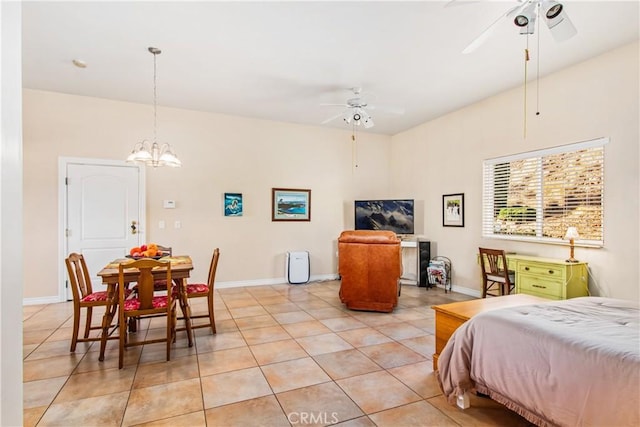 bedroom with light tile patterned floors, a notable chandelier, and baseboards
