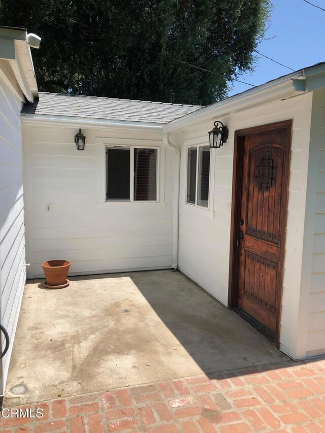 1755 Morada Pl, Altadena, CA 91001 - doorway to property with a patio area and roof with shingles