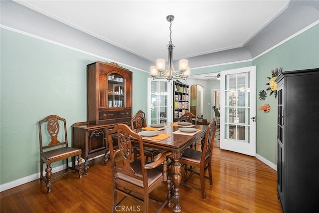 dining space featuring french doors, baseboards, and wood finished floors