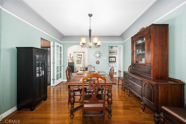 dining area with baseboards, wood finished floors, a notable chandelier, and visible vents