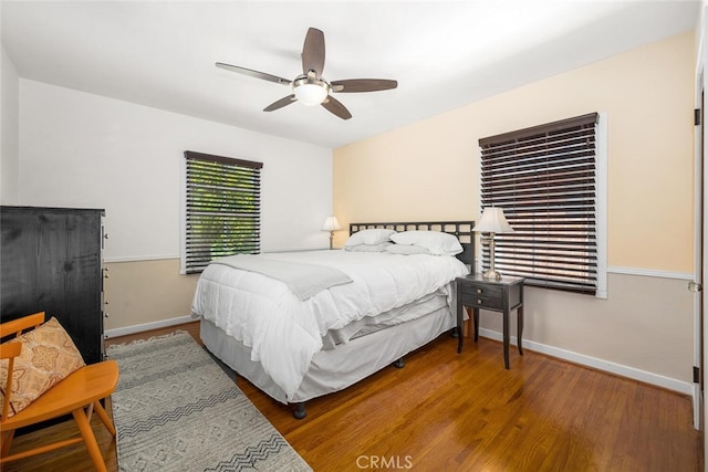 bedroom with baseboards, ceiling fan, and wood finished floors