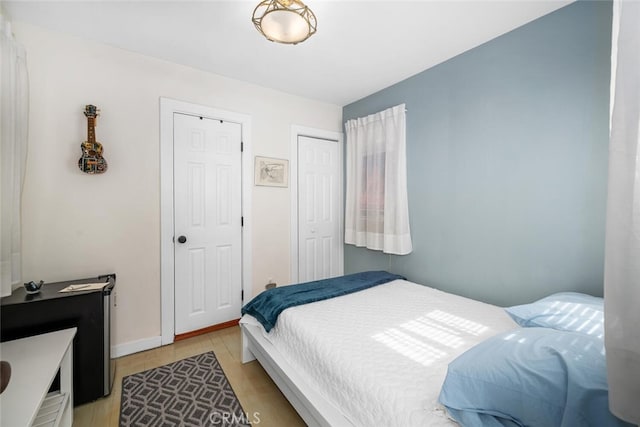 bedroom with light wood-style floors and baseboards