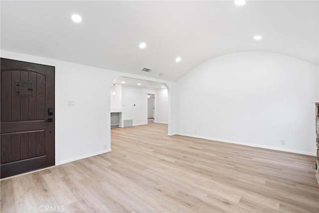foyer featuring visible vents, light wood-style flooring, recessed lighting, and arched walkways