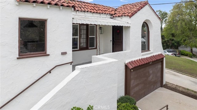 6010 S Verdun Ave, Los Angeles, CA 90043 - mediterranean / spanish home with stucco siding, a tiled roof, and an attached garage
