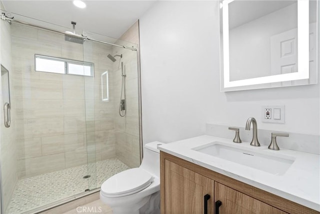 full bathroom with toilet, a stall shower, and vanity