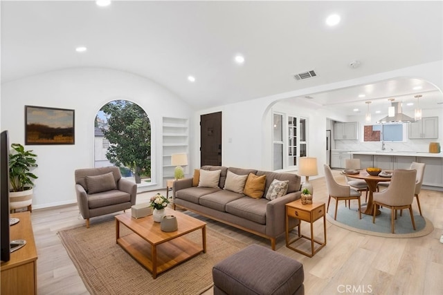 6010 S Verdun Ave, Los Angeles, CA 90043 - living room with arched walkways, light wood-style flooring, recessed lighting, plenty of natural light, and vaulted ceiling