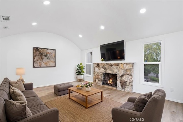 6010 S Verdun Ave, Los Angeles, CA 90043 - living room with vaulted ceiling, a stone fireplace, recessed lighting, wood finished floors, and baseboards