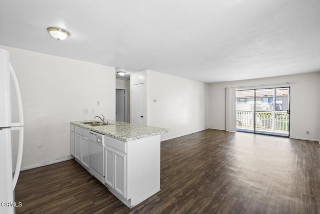 kitchen with a sink, a peninsula, dark wood-style floors, open floor plan, and white appliances