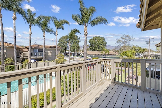deck with a residential view and fence