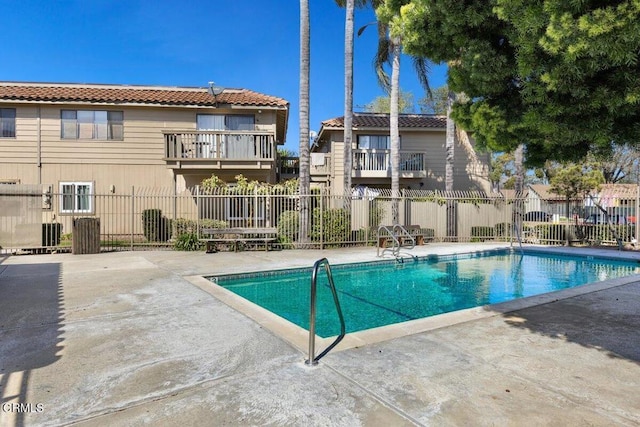 pool with fence and a patio