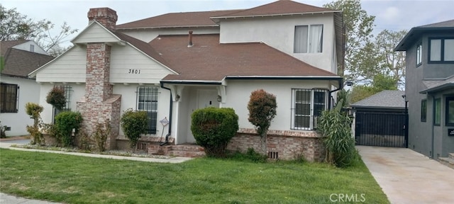 view of front of home with a front yard, stucco siding, and a chimney
