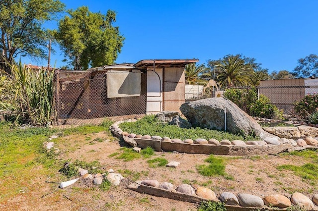 exterior space with fence, an outdoor structure, and exterior structure