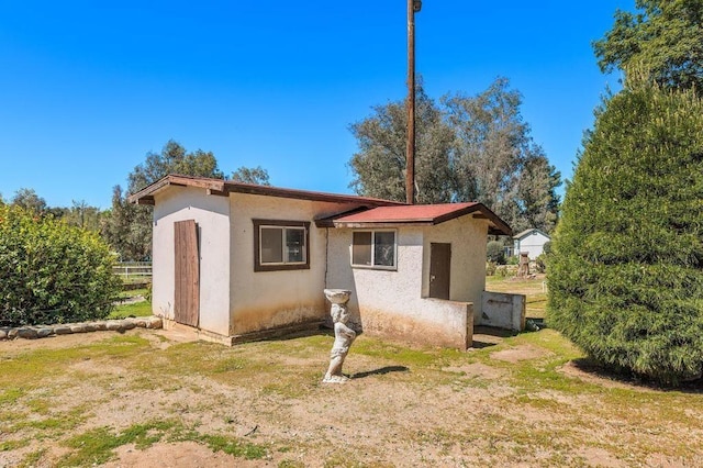 view of outbuilding with fence