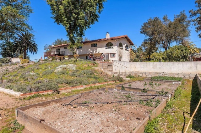 view of yard featuring a garden, fence, a deck, and stairway