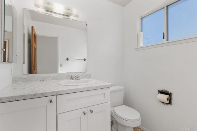 bathroom with toilet and vanity