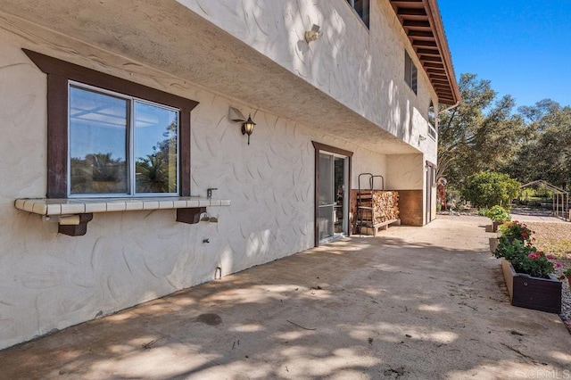 view of property exterior with a patio and stucco siding
