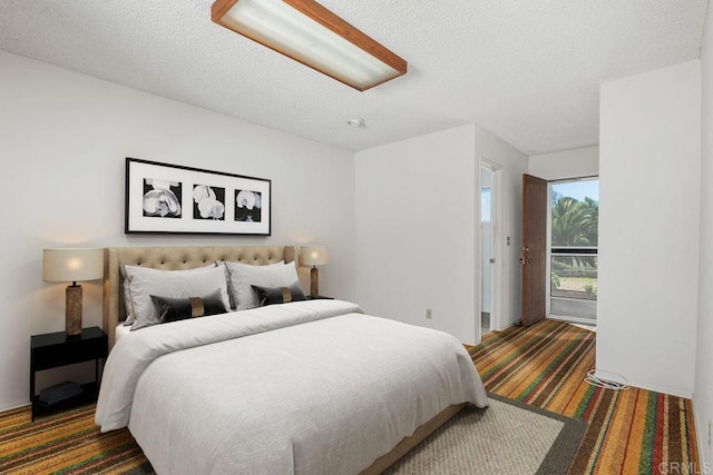 carpeted bedroom featuring a textured ceiling