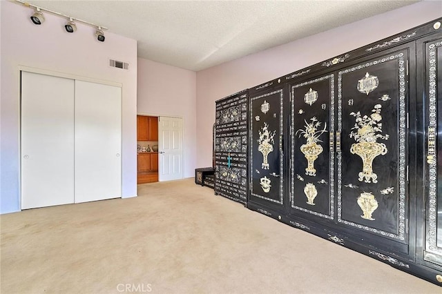 1135 Summitridge Dr, Diamond Bar, CA 91765 - interior space with carpet floors, a textured ceiling, visible vents, and track lighting