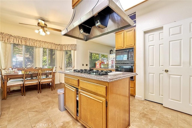 1135 Summitridge Dr, Diamond Bar, CA 91765 - kitchen with light stone counters, range hood, a kitchen island, black appliances, and ceiling fan