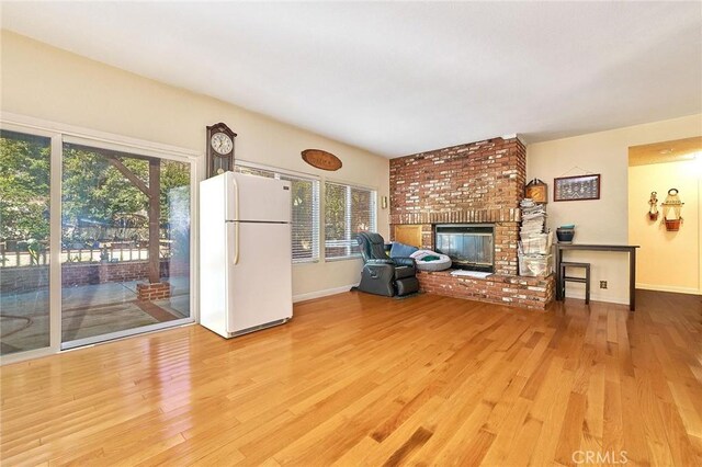 1135 Summitridge Dr, Diamond Bar, CA 91765 - unfurnished living room with baseboards, light wood-style flooring, and a brick fireplace