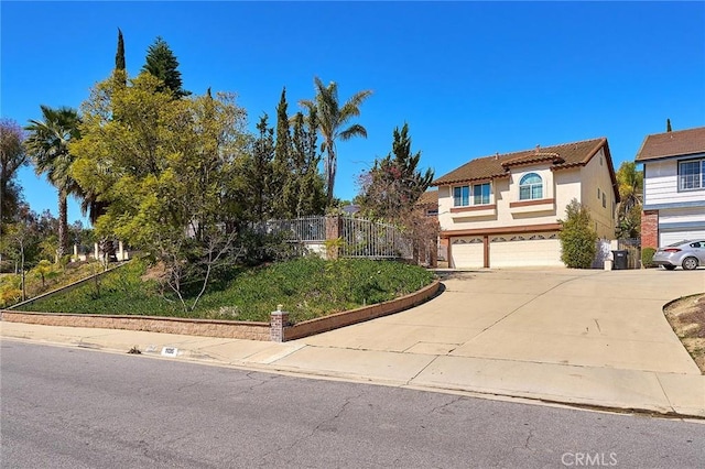 1135 Summitridge Dr, Diamond Bar, CA 91765 - view of front of house featuring a tile roof, concrete driveway, stucco siding, fence, and an attached garage