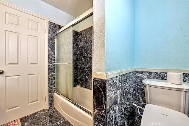1135 Summitridge Dr, Diamond Bar, CA 91765 - full bathroom with tile walls, marble finish floor, toilet, enclosed tub / shower combo, and wainscoting