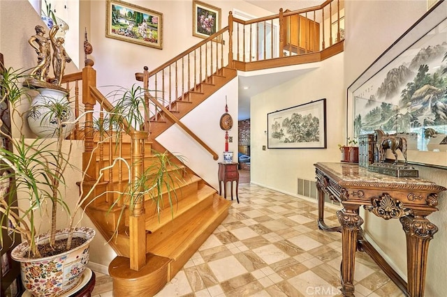 1135 Summitridge Dr, Diamond Bar, CA 91765 - stairway featuring baseboards, visible vents, and a high ceiling