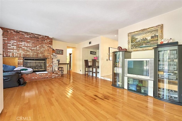 1135 Summitridge Dr, Diamond Bar, CA 91765 - living area featuring beverage cooler, wood finished floors, a dry bar, and a brick fireplace
