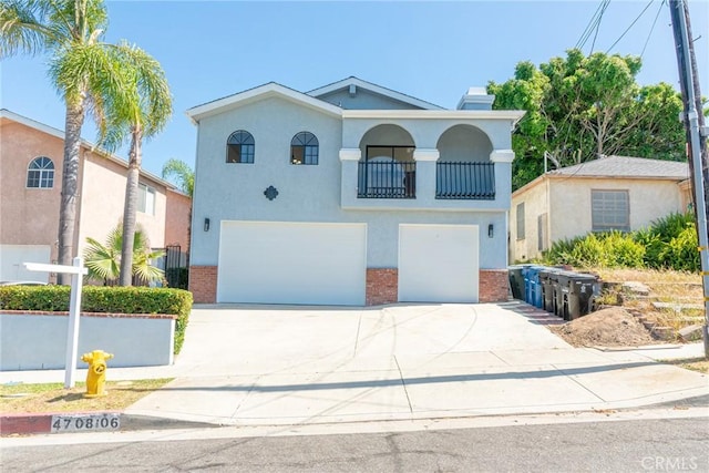 4706 W 168th St, Lawndale, CA 90260 - mediterranean / spanish home with an attached garage, concrete driveway, stucco siding, and brick siding
