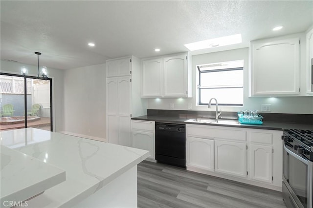 4706 W 168th St, Lawndale, CA 90260 - kitchen with black dishwasher, gas range, white cabinets, recessed lighting, and dark stone counters