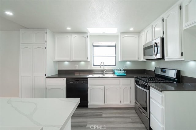 4706 W 168th St, Lawndale, CA 90260 - kitchen featuring appliances with stainless steel finishes, white cabinets, recessed lighting, and light wood finished floors
