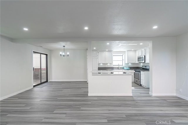 4706 W 168th St, Lawndale, CA 90260 - kitchen with stainless steel appliances, a chandelier, recessed lighting, white cabinetry, and open floor plan