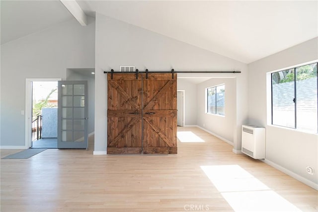 4706 W 168th St, Lawndale, CA 90260 - unfurnished room with light wood finished floors, beamed ceiling, a barn door, heating unit, and high vaulted ceiling