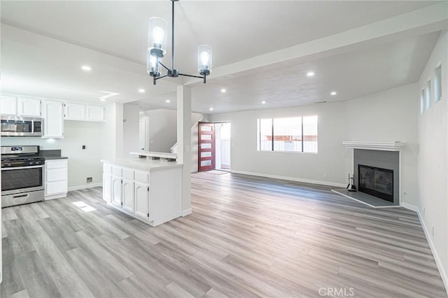 4706 W 168th St, Lawndale, CA 90260 - unfurnished living room featuring light wood-style floors, recessed lighting, a glass covered fireplace, and a chandelier