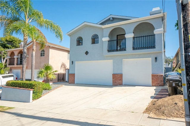 4706 W 168th St, Lawndale, CA 90260 - mediterranean / spanish-style home with a garage, brick siding, a balcony, and stucco siding