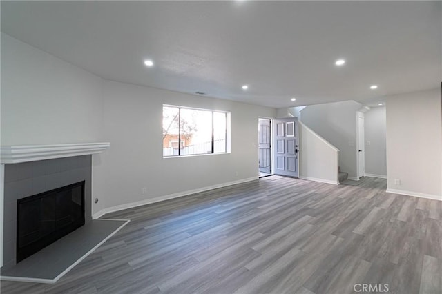 4706 W 168th St, Lawndale, CA 90260 - unfurnished living room with stairs, wood finished floors, a glass covered fireplace, and recessed lighting