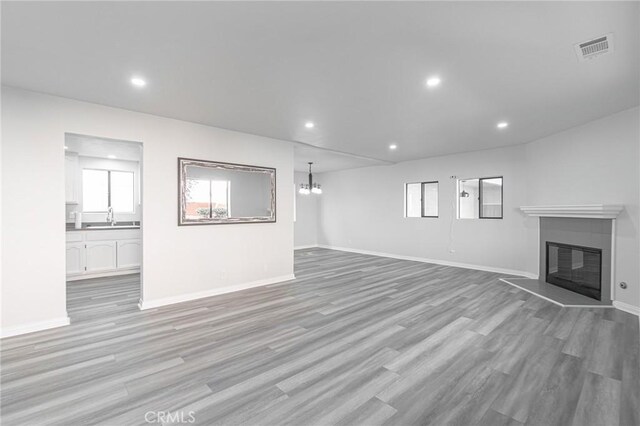 4706 W 168th St, Lawndale, CA 90260 - unfurnished living room featuring light wood-style flooring, a glass covered fireplace, and recessed lighting