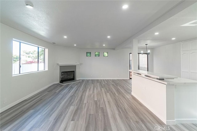 4706 W 168th St, Lawndale, CA 90260 - unfurnished living room with recessed lighting, light wood-style floors, a fireplace with raised hearth, and a chandelier
