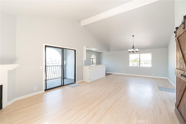 4706 W 168th St, Lawndale, CA 90260 - unfurnished living room featuring a barn door, beam ceiling, light wood finished floors, a fireplace, and a chandelier