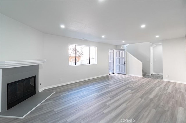 4706 W 168th St, Lawndale, CA 90260 - unfurnished living room with wood finished floors, stairway, recessed lighting, and a glass covered fireplace