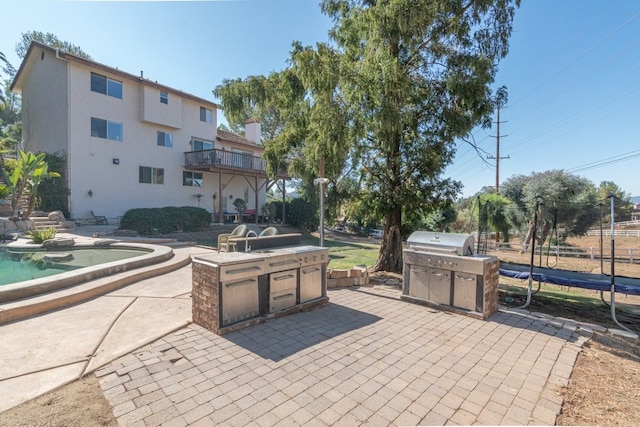 view of patio / terrace with a trampoline and a grill