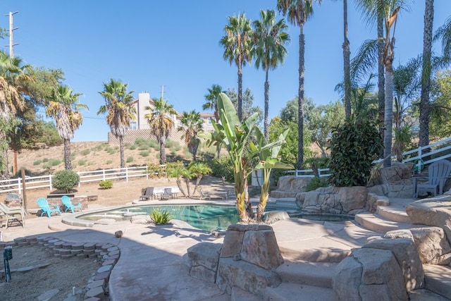 pool featuring a patio and fence