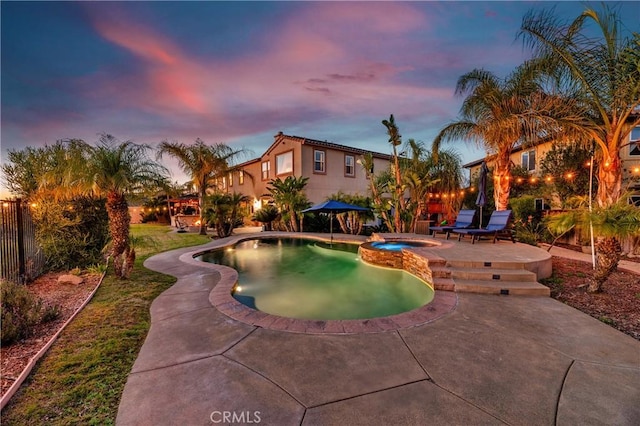 16720 S Peak Ct, Riverside, CA 92503 - pool at dusk featuring a patio and a pool with connected hot tub