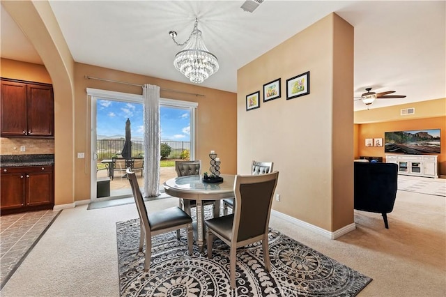 16720 S Peak Ct, Riverside, CA 92503 - dining space featuring light colored carpet, a chandelier, ceiling fan, and arched walkways